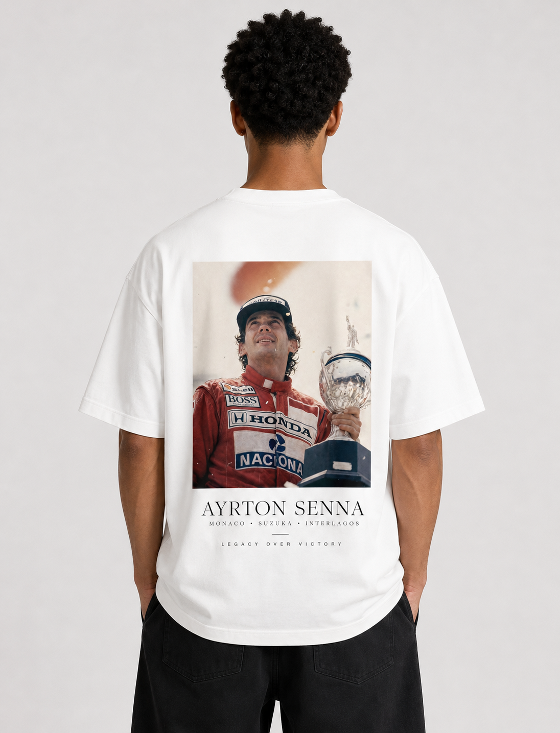 Person wearing a white t-shirt with Ayrton Senna graphic on the back