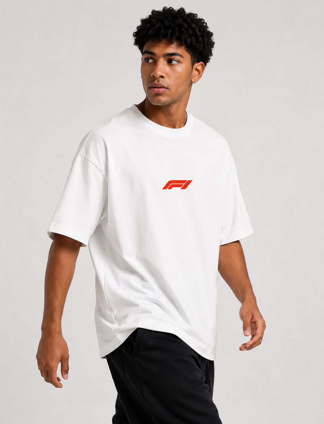 Person wearing a white t-shirt with a red logo on a plain background