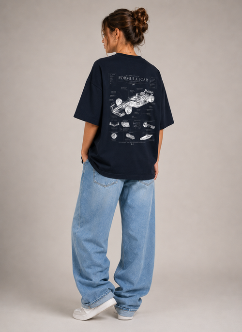 Person wearing a black t-shirt with a car diagram design on the back, standing against a plain background.