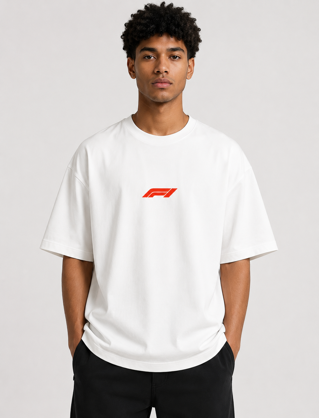 Person wearing a white t-shirt with a red logo on a plain background
